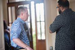 Two men having a conversation at a event