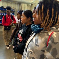 Students watching and listening during maker space tour